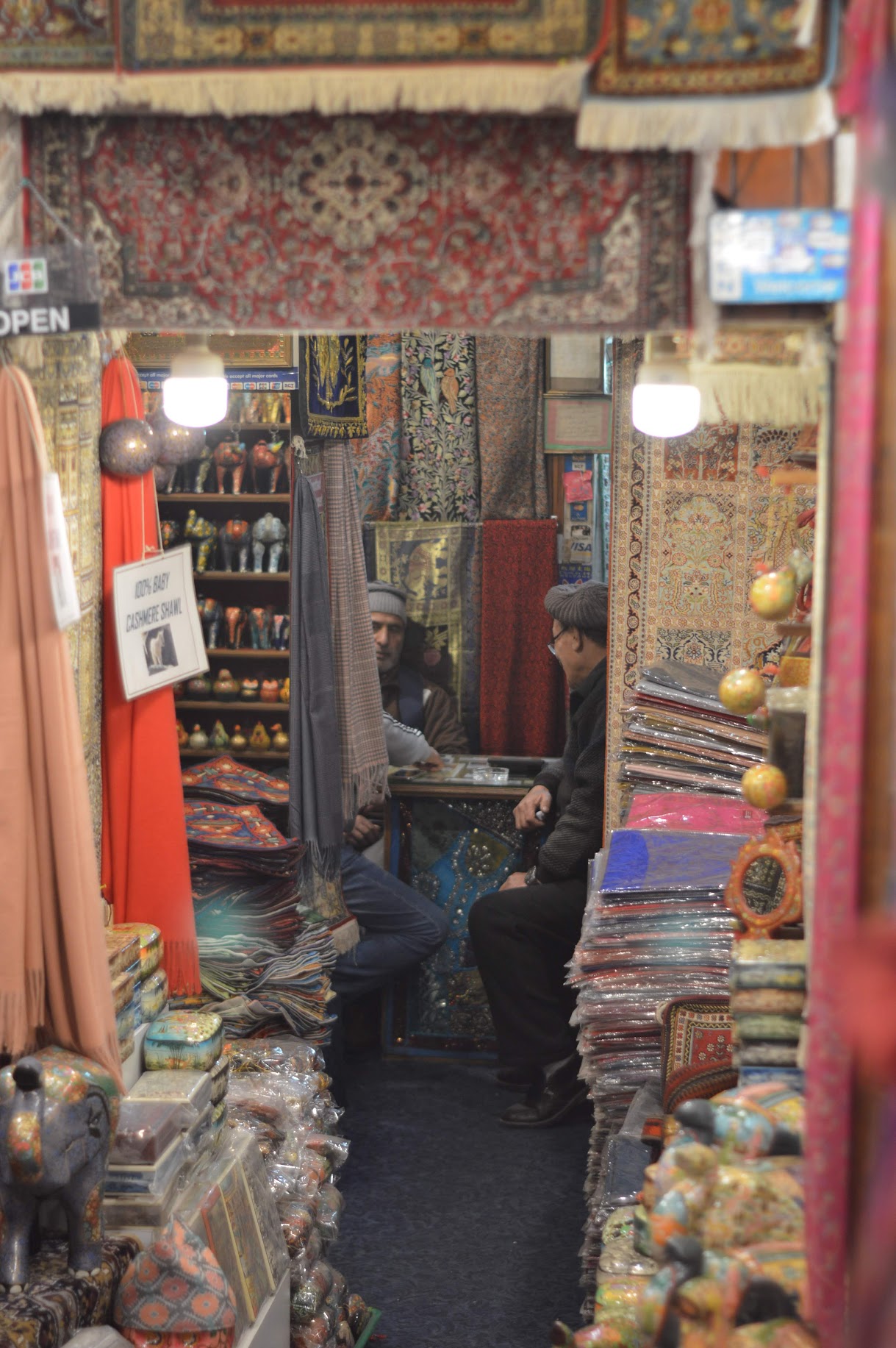 Carpet shop owner converses with friend, Nepal